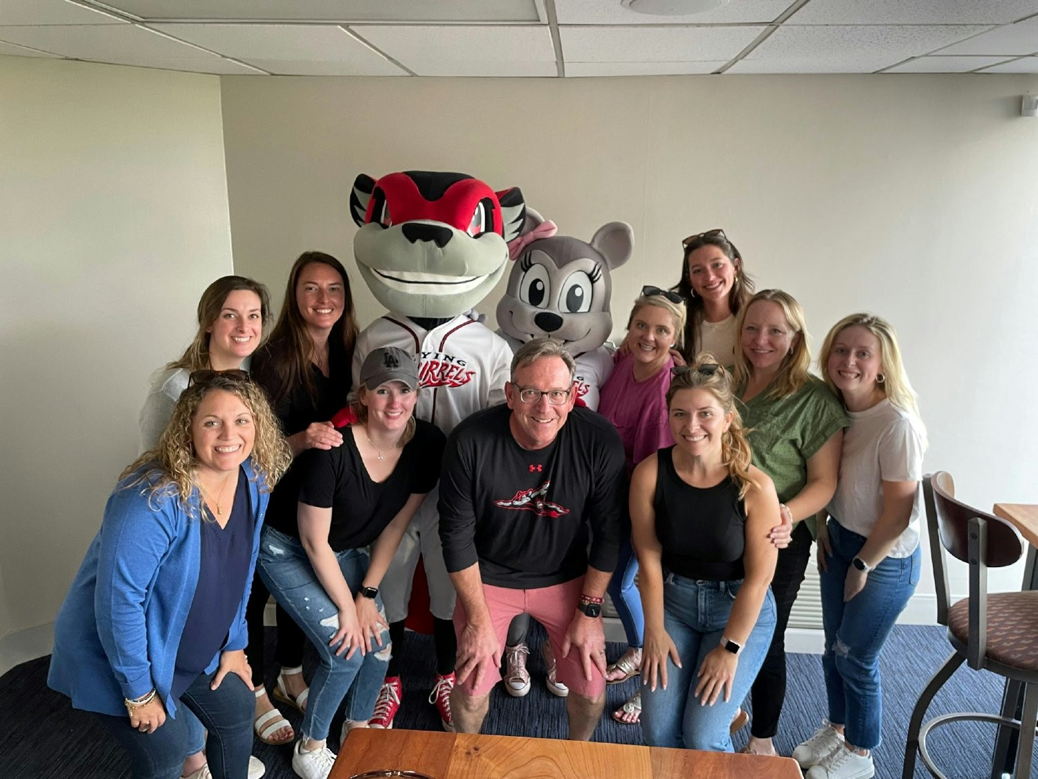 Members of the Marketing and People Strategies teams cheering on the Richmond Flying Squirrels baseball team.