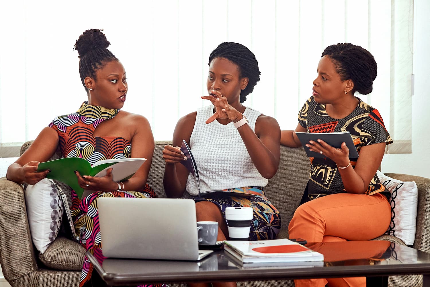  three Black women discussing a business problem