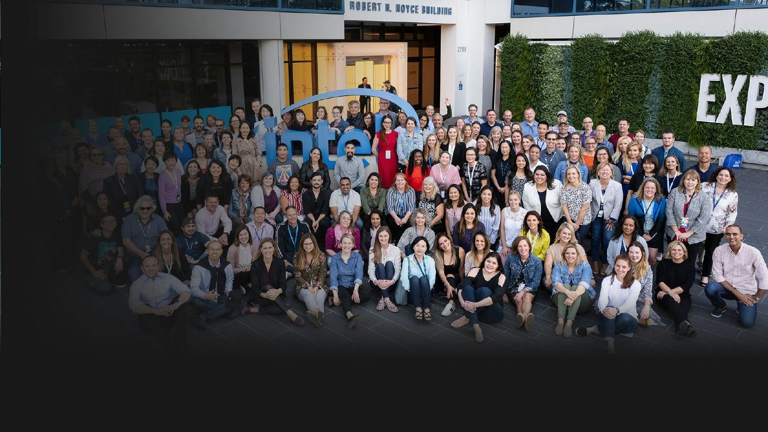 Group photo of Intel employees gathered in front of their office building.