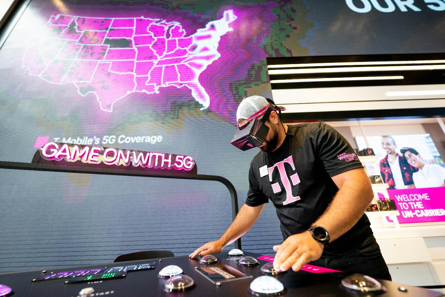 A mobile expert demonstrates  how 5G is the real game-changer for customers at a T-Mobile signature store.