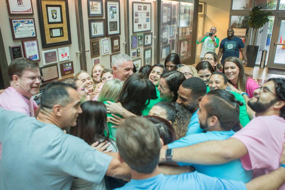 A giant group hug following a diversity event, because we enjoy being one family at Ultimate Software.