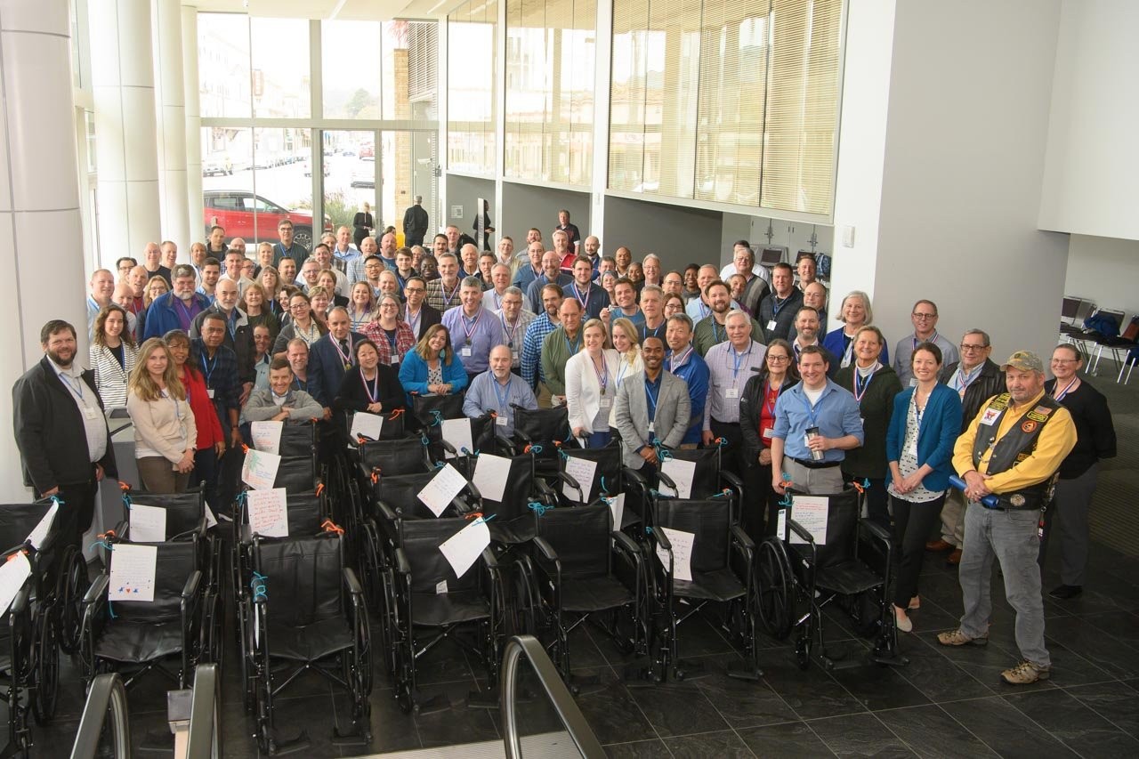 Employees building wheelchairs for US Veterans at annual business planning meeting