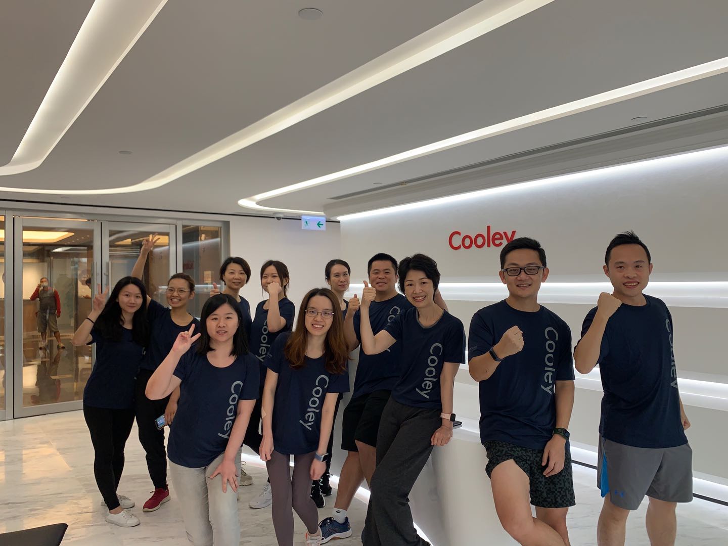 Members of Cooley's Hong Kong office pose in the lobby area.