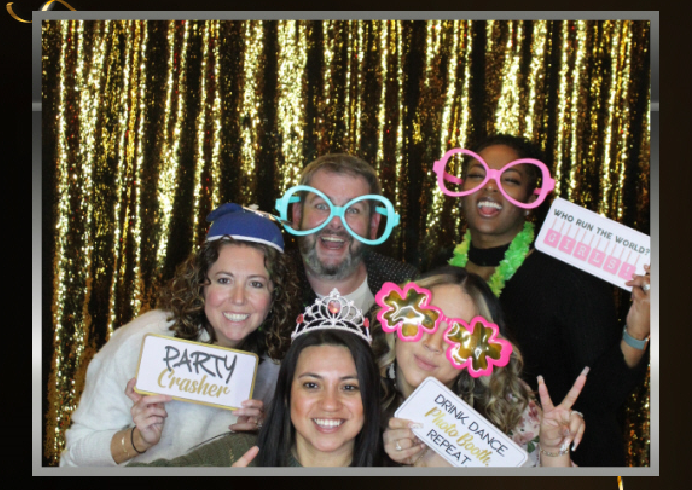 Employees having fun with the photo booth at our annual party. 
