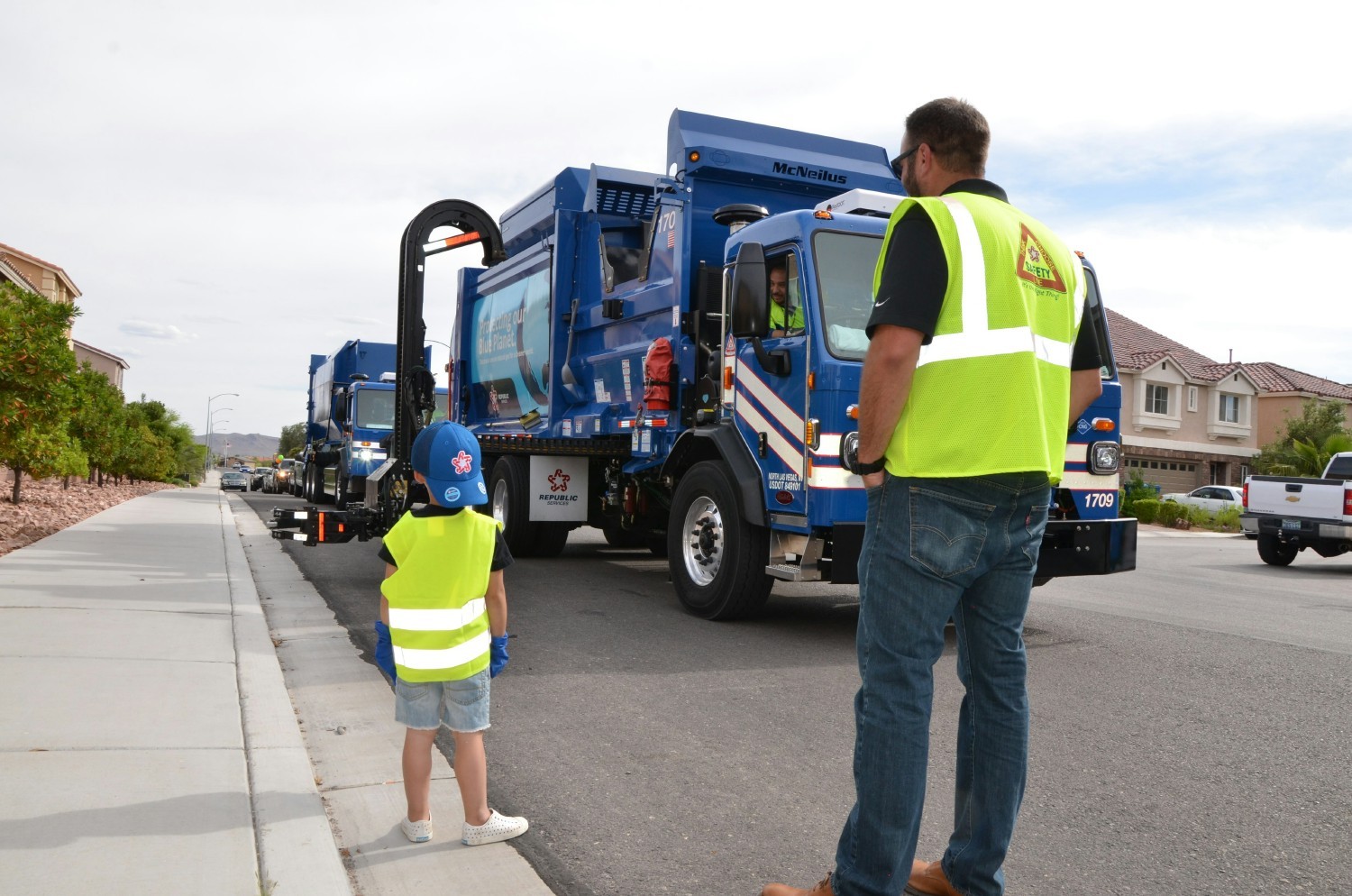 Team members organize a parade for a birthday. The team surprised the boy with 2 trucks and a fleet of support vehicles.