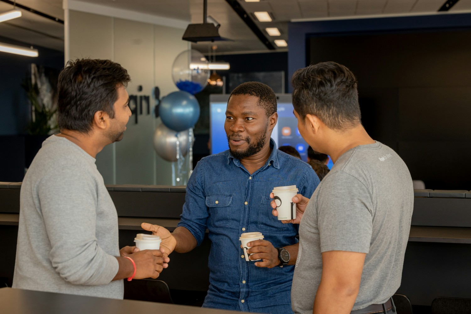 Teams often meet in our global offices' collaboration spaces for a quick stand-up or just to catch up with each other.