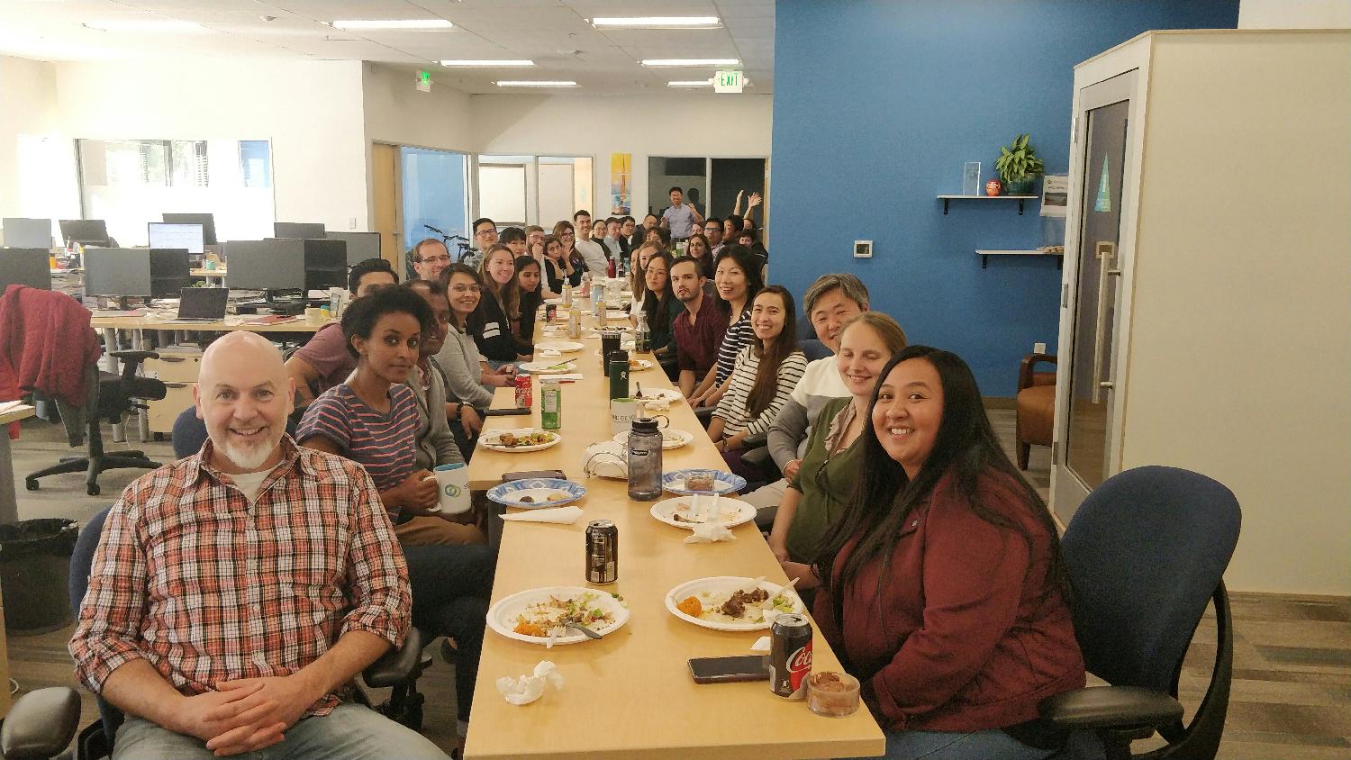 The team at our annual Thanksgiving potluck. Every year we line up our desks for true family-style dining. 
