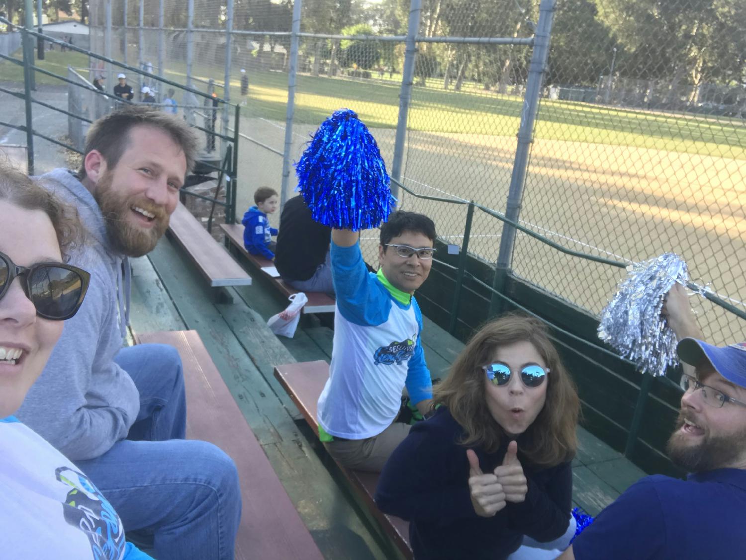 SGers cheer on our company softball team, the Second GeneHomers, at a game in our local parks & rec league. 