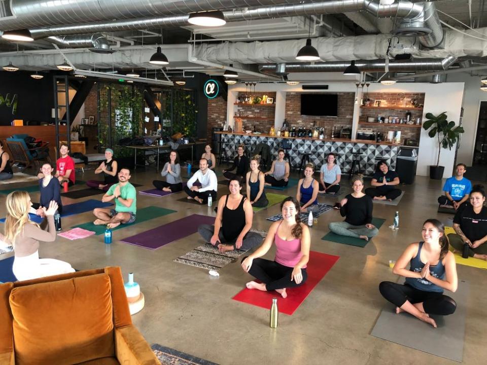 Classy employees take part in the company’s wellness initiative through a morning yoga class