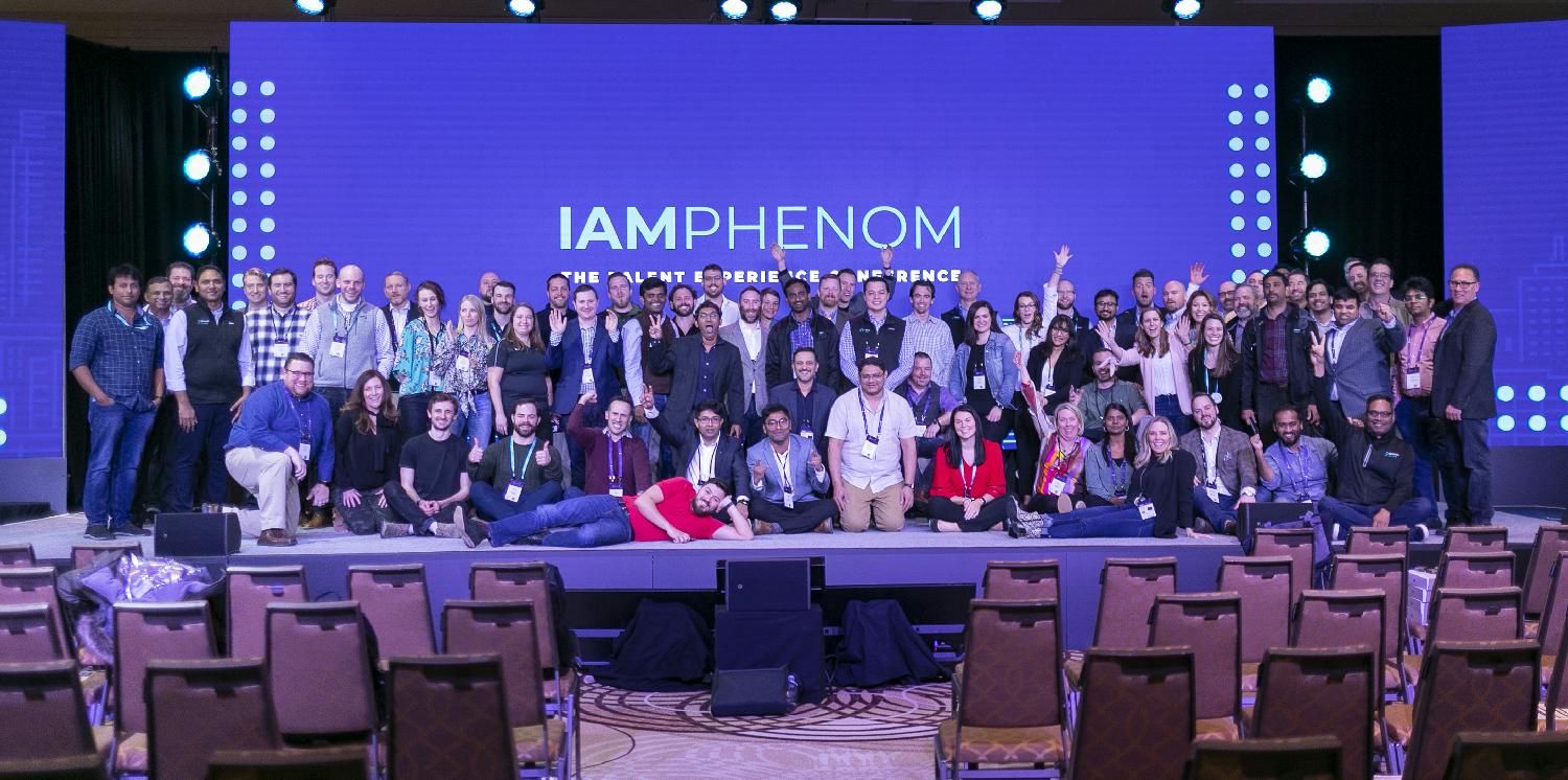 Phenom employees gather on stage for a group photo during our talent experience conference IAMPHENOM.