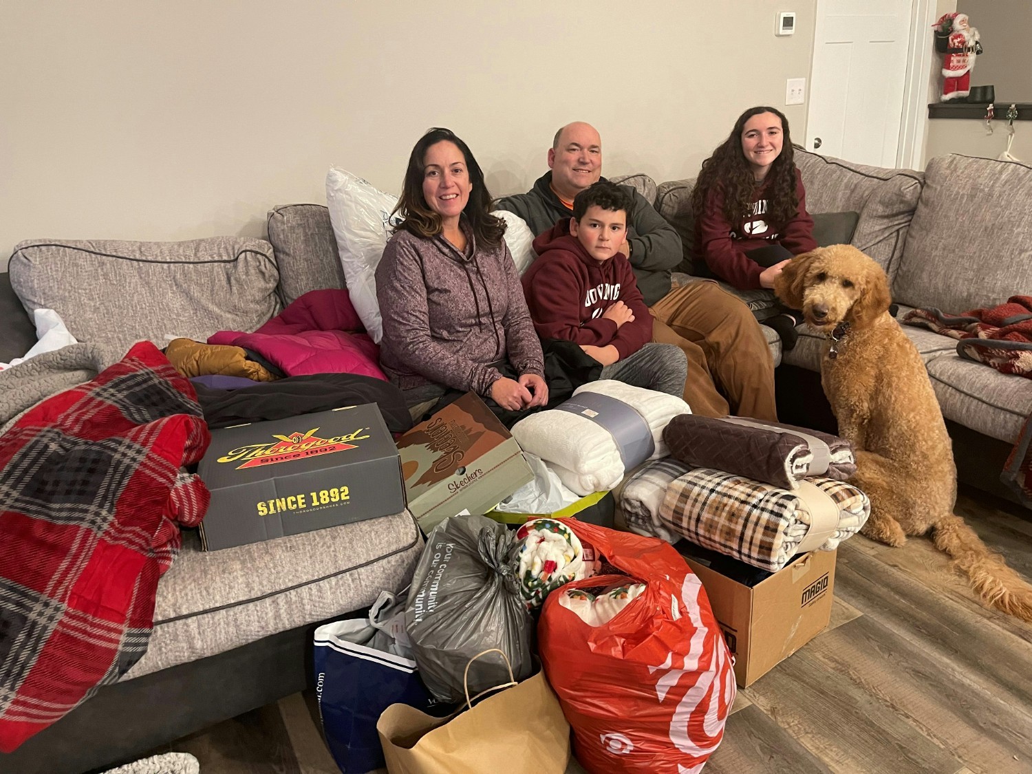 Team member Leanne Benson and family with donations received from team members after they lost their home to a fire. 