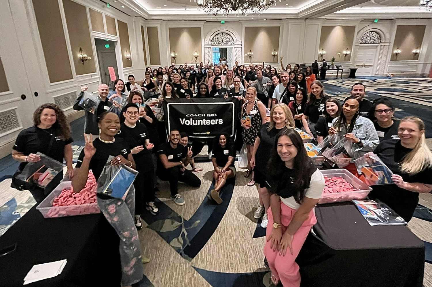 Coach and Stuart Weitzman employees come together to volunteer at a Store Managers conference. 