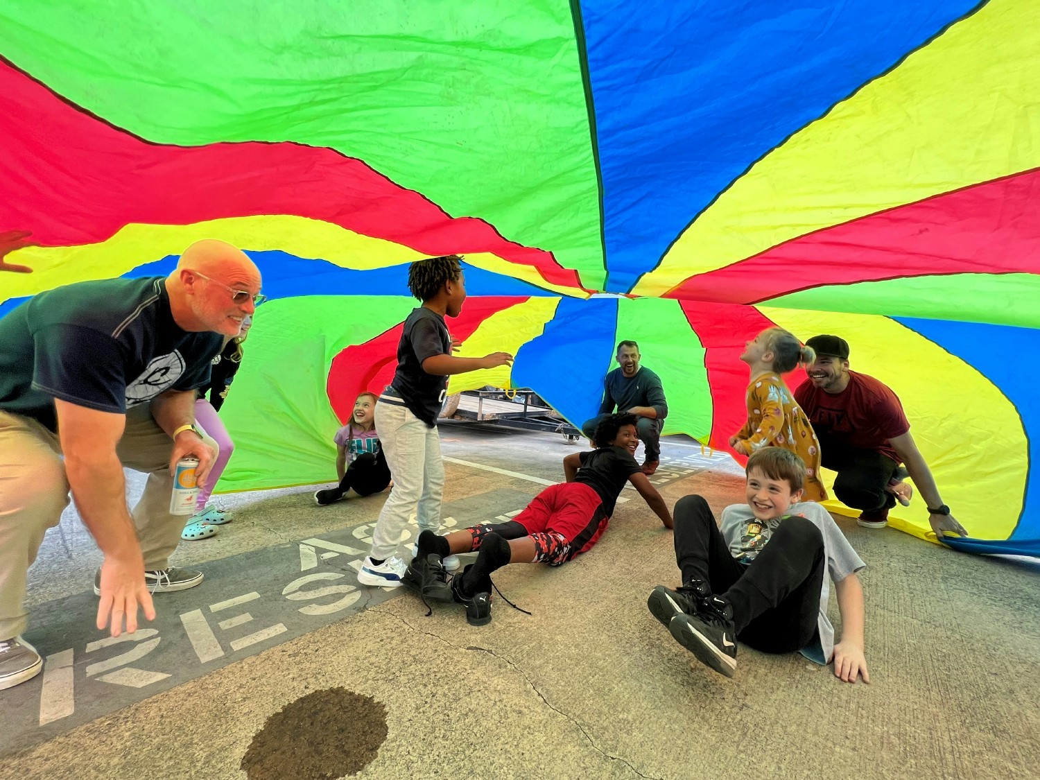 ACC's CEO, Richie Deason, participating in the parachute play with the kids.