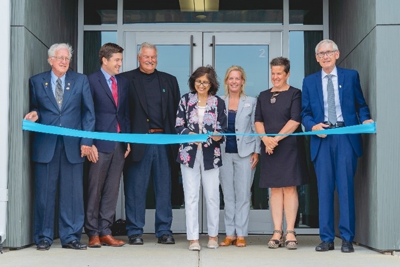 Nexus CEO Mariam Darsot cuts the ceremonial ribbon at our new facility joined by Gov. Tony Evers and other dignitaries.