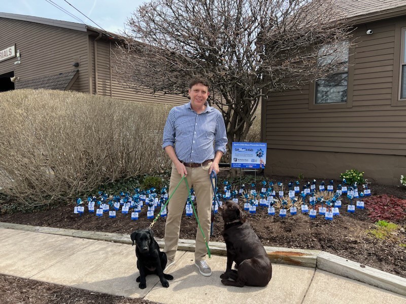 Company President with his family dogs, Tillie and Mabel, showing their support for the McMahon Ryan Advocacy Center