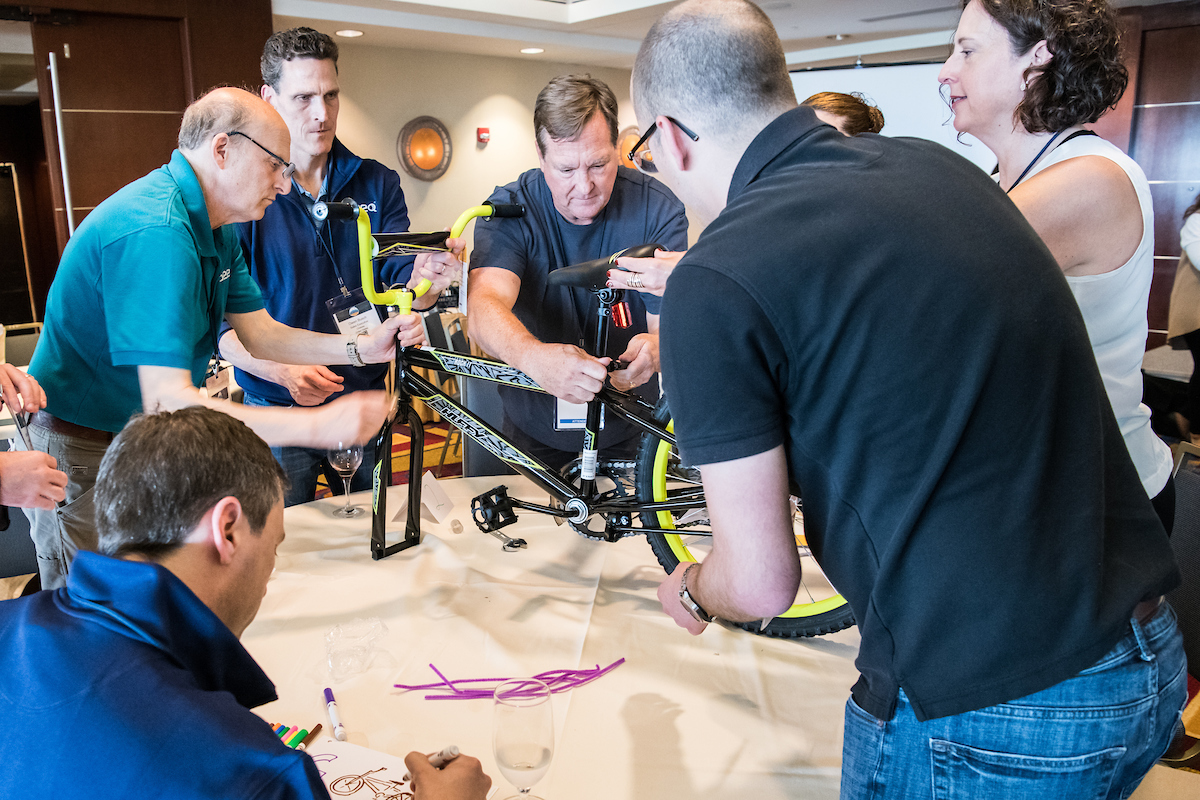 Seeqers build bikes to be donated to charity during the Washington D.C. all-company meetup in 2019.
