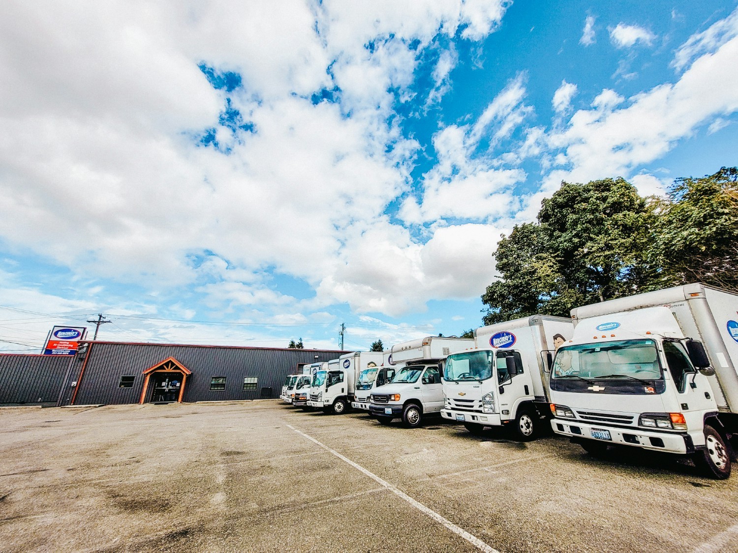 Several installation vehicles with our office and warehouse building
