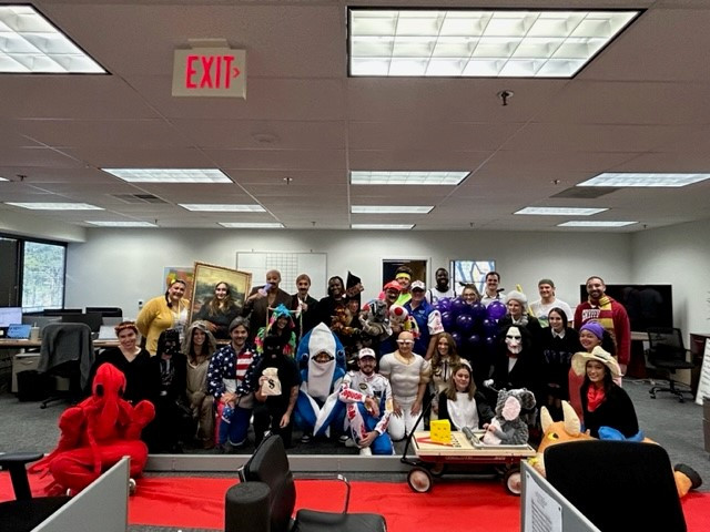 Alumni Staffing's 2023 Halloween office party!  Each year we roll out a red carpet for our annual costume contest.