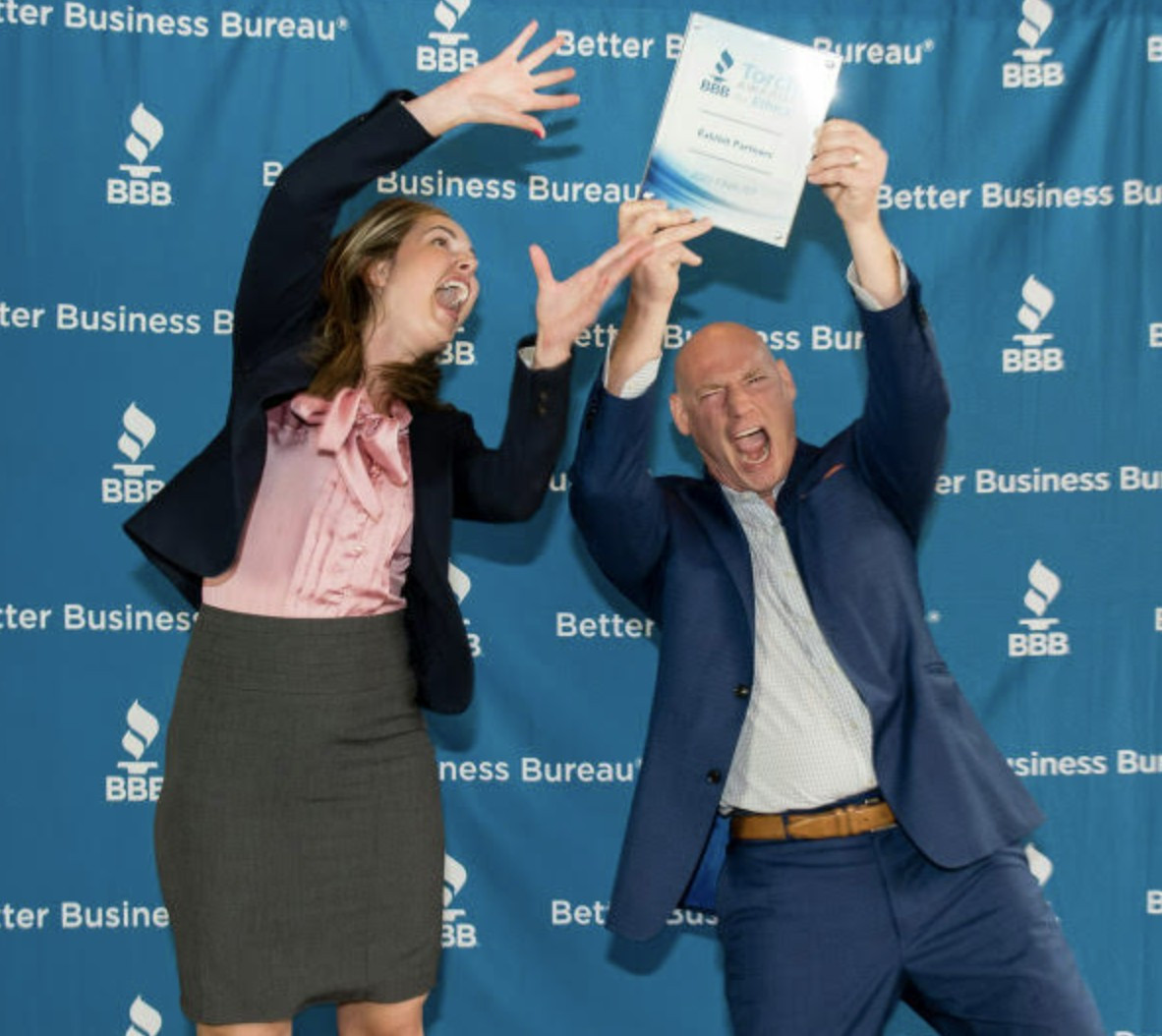 CEO and exec assistant taking a goofy photo at a Ethics Award Ceremony through BBB Torch awards
