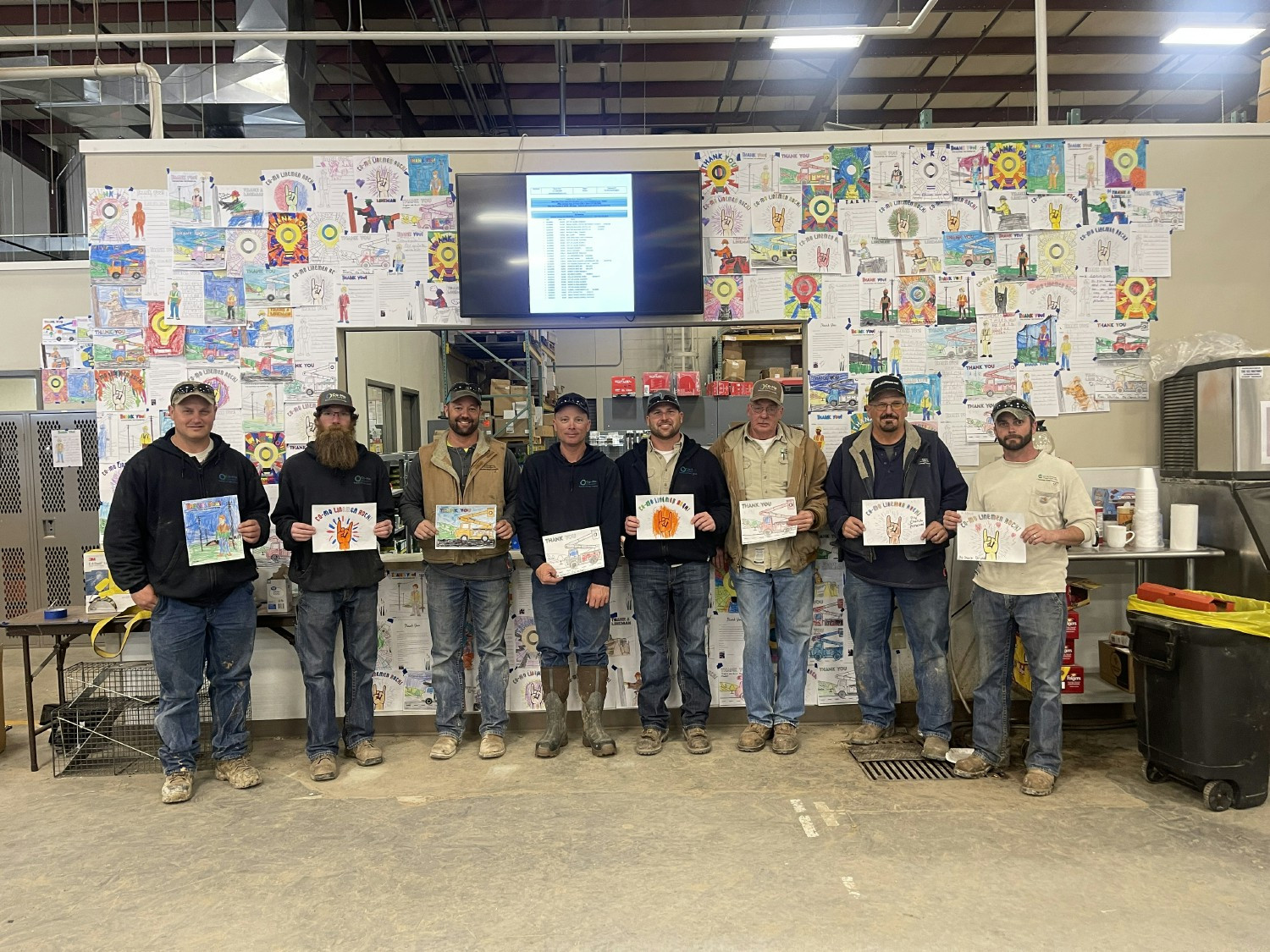 Co-Mo Connect linemen hold coloring pages local area schools sent in for Linemen Appreciation Day. 