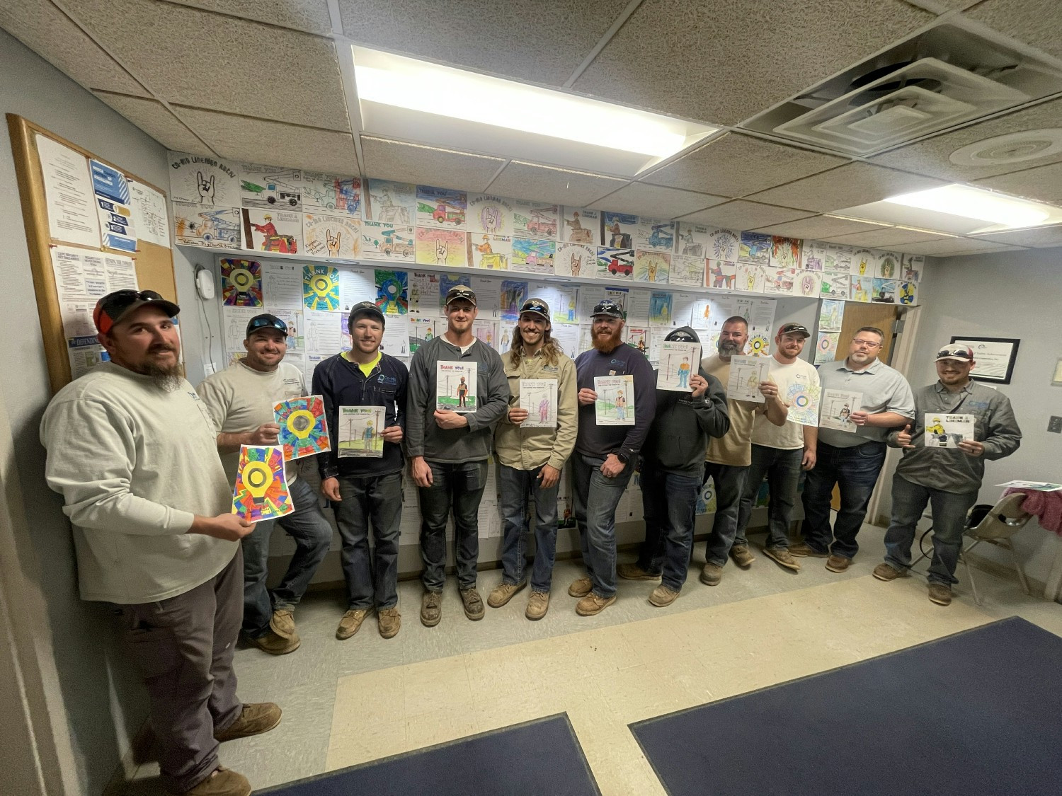 Co-Mo Connect linemen hold coloring pages local area schools sent in for Linemen Appreciation Day. 