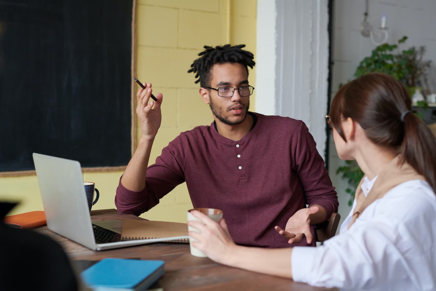  A woman in a white blouse listens attentively to an employee during a Proximity Initiative session, a program that helps leaders connect with employees and learn about their experiences.