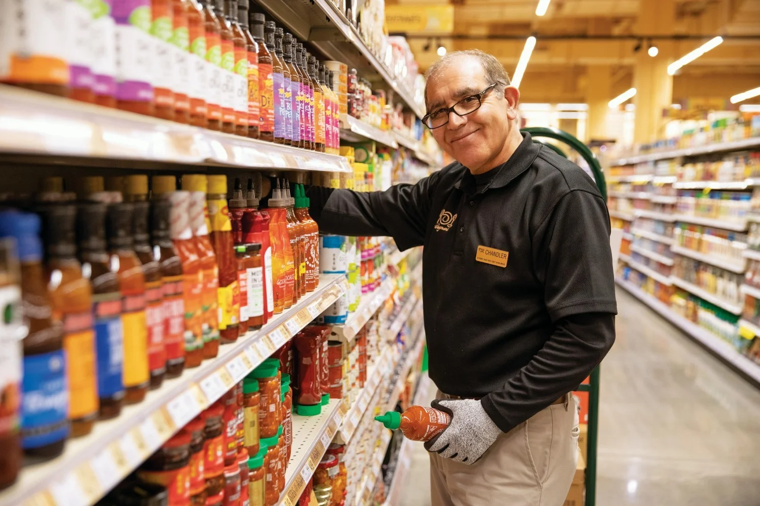  An employee at Wegman's Food Markets, one of the Fortune Best Workplaces in Retail, stocks the shelves.