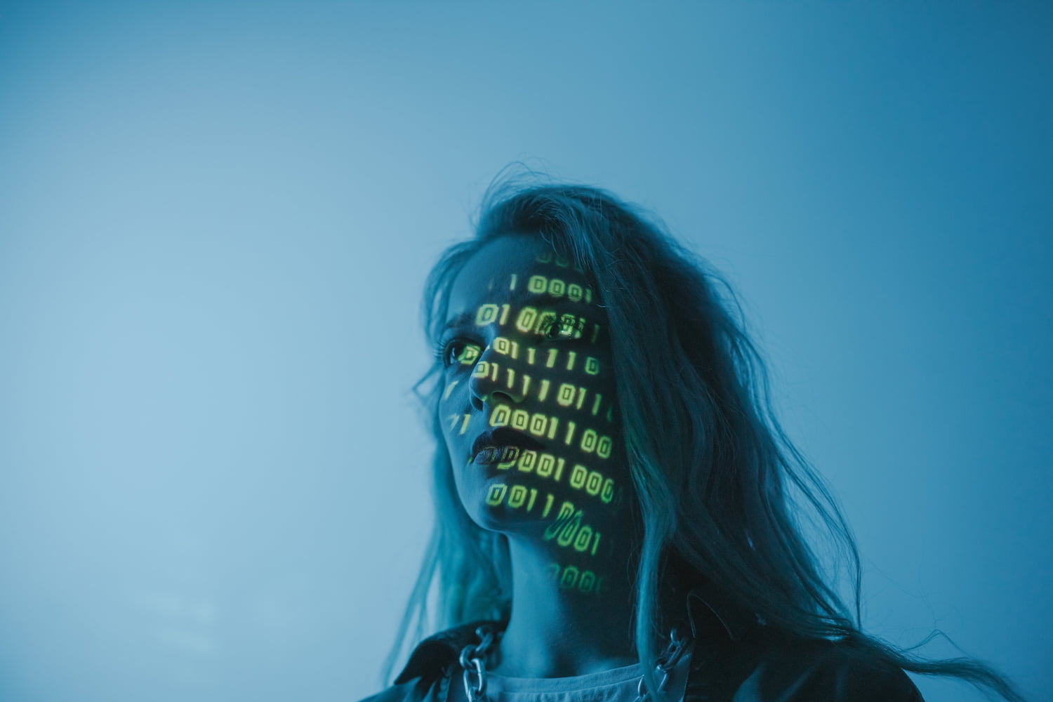  woman with ones and zeros projected on her face