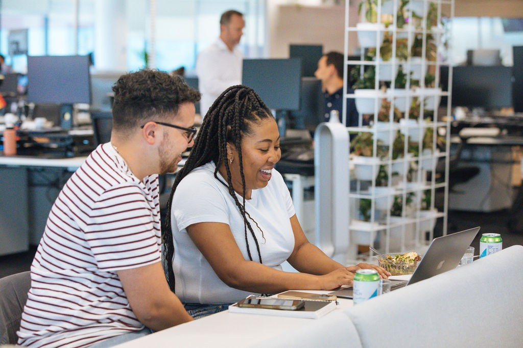  Rokt employees working in an office