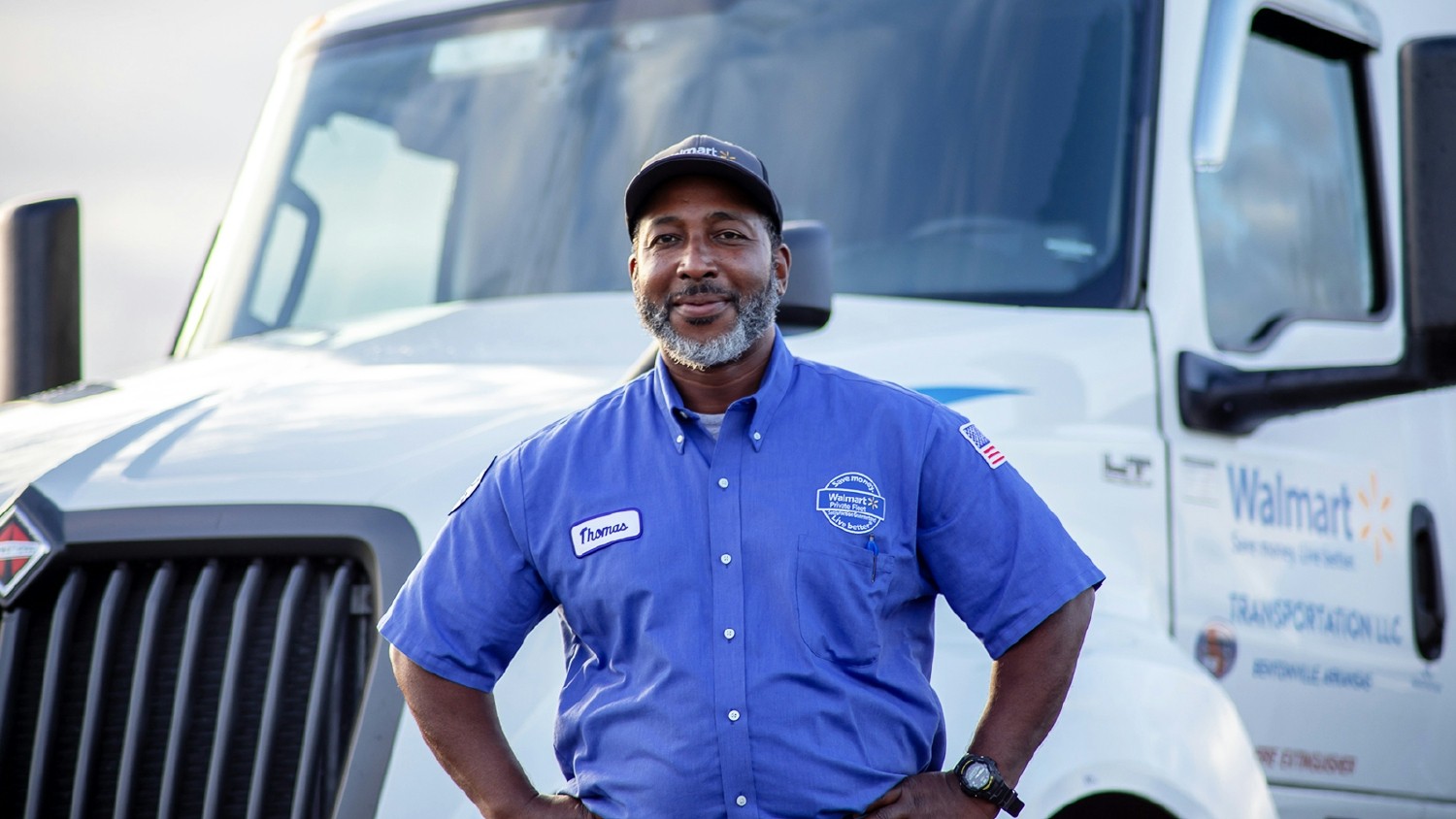  Walmart driver stands in front of his rig