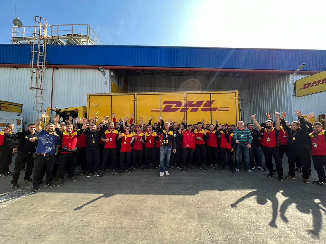  Employees at DHL Express share a moment of fun at their shipping center.