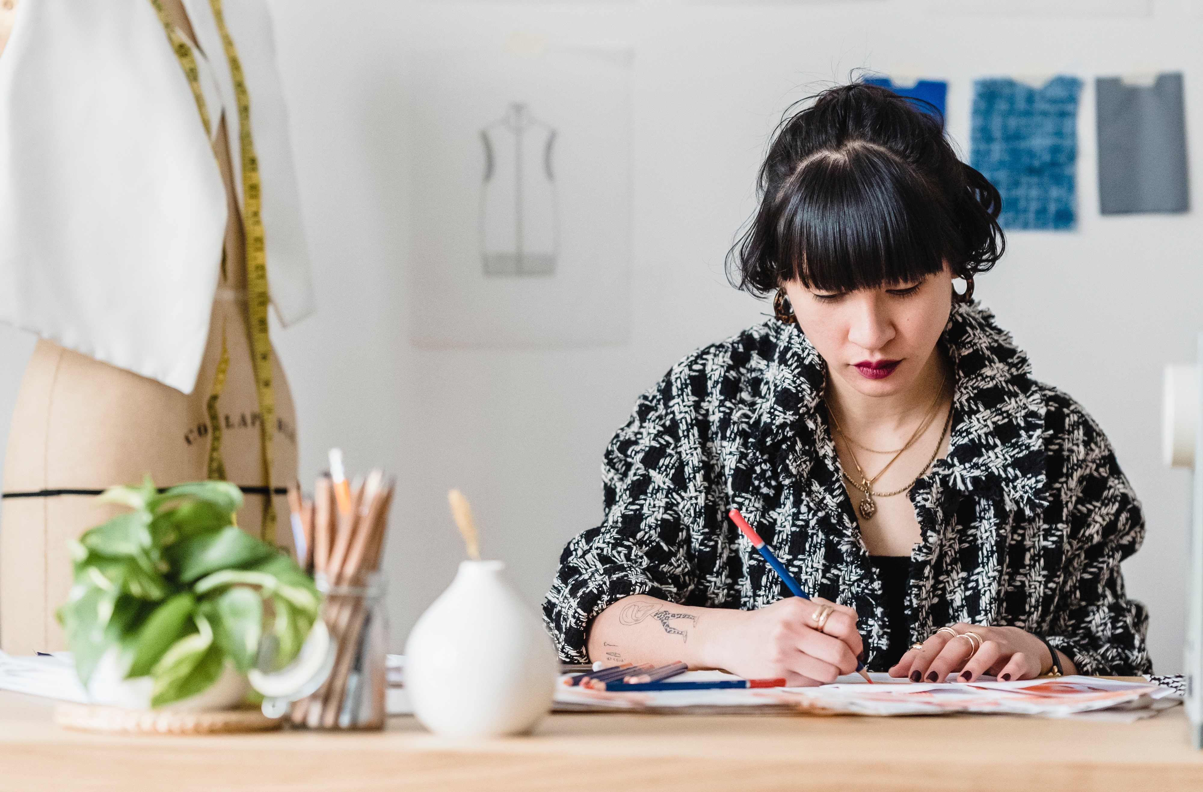  Asian American employee draws fashion sketches at work