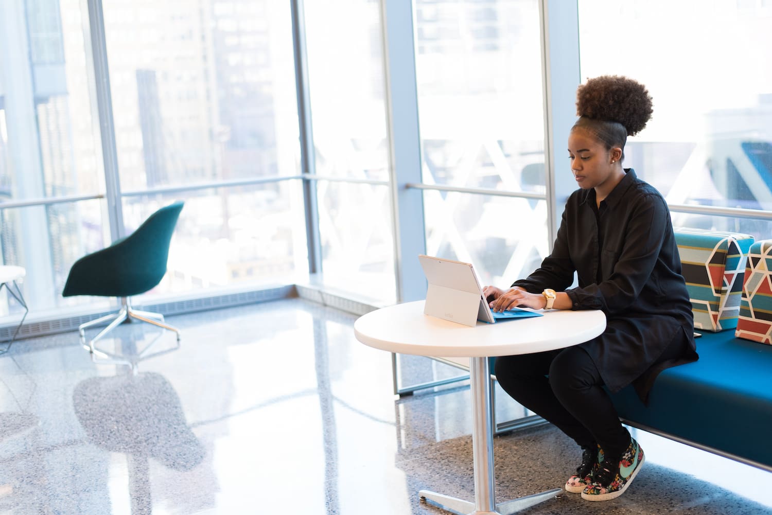  Black woman working on a laptop in the office