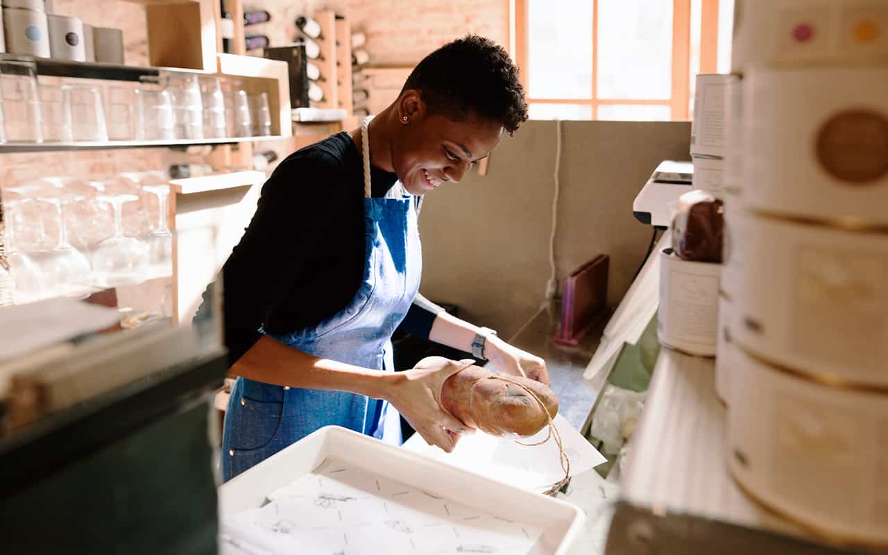  A young worker packages a loaf of bread