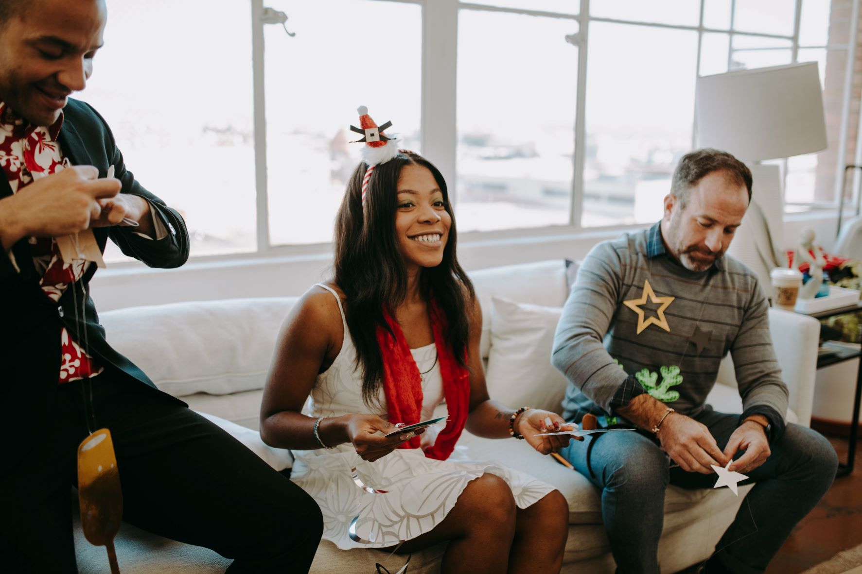  Three employees laugh as they celebrate at their office party