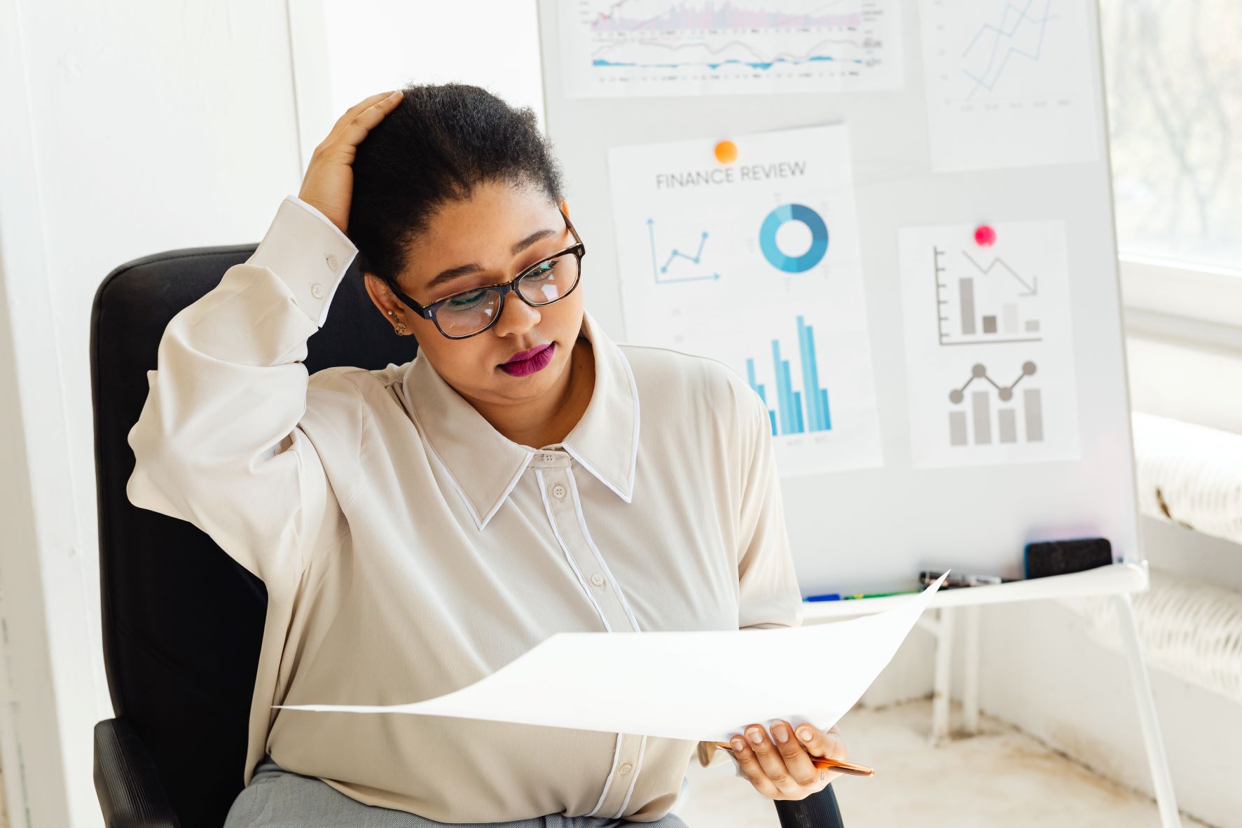  Black manager looks anxiously at business accounting 