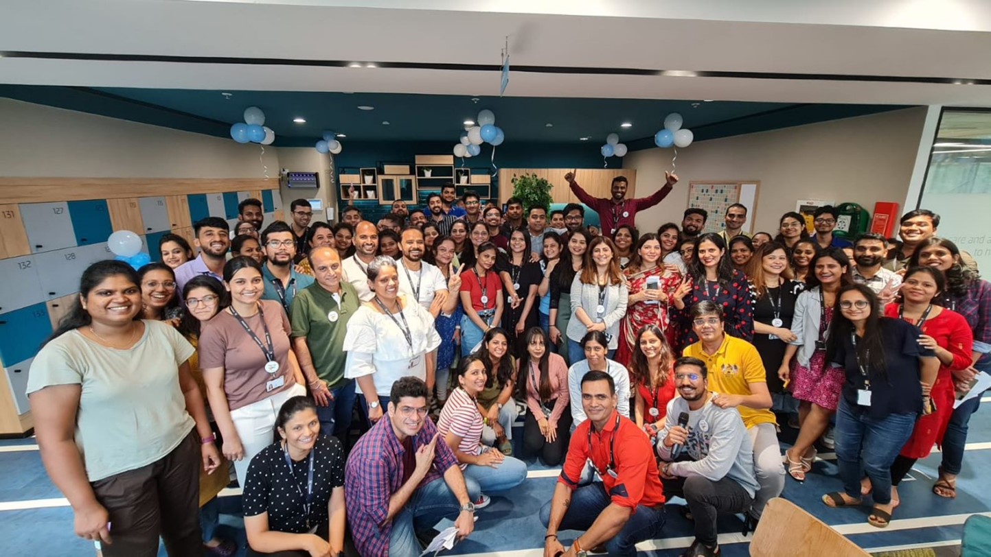  The 2022 best workplaces in Asia, is depicted with employees at shipping company Maersk gather for a group photo.