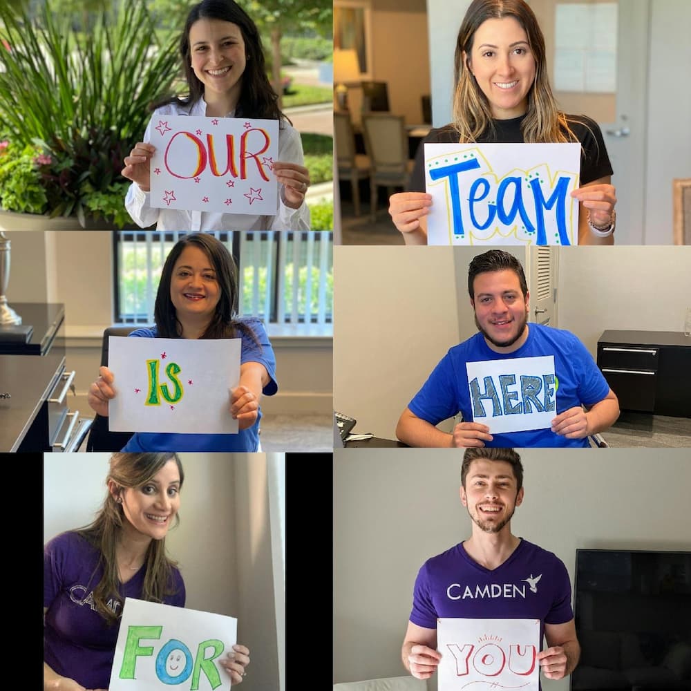  Group of Camden employees holding signs that say 