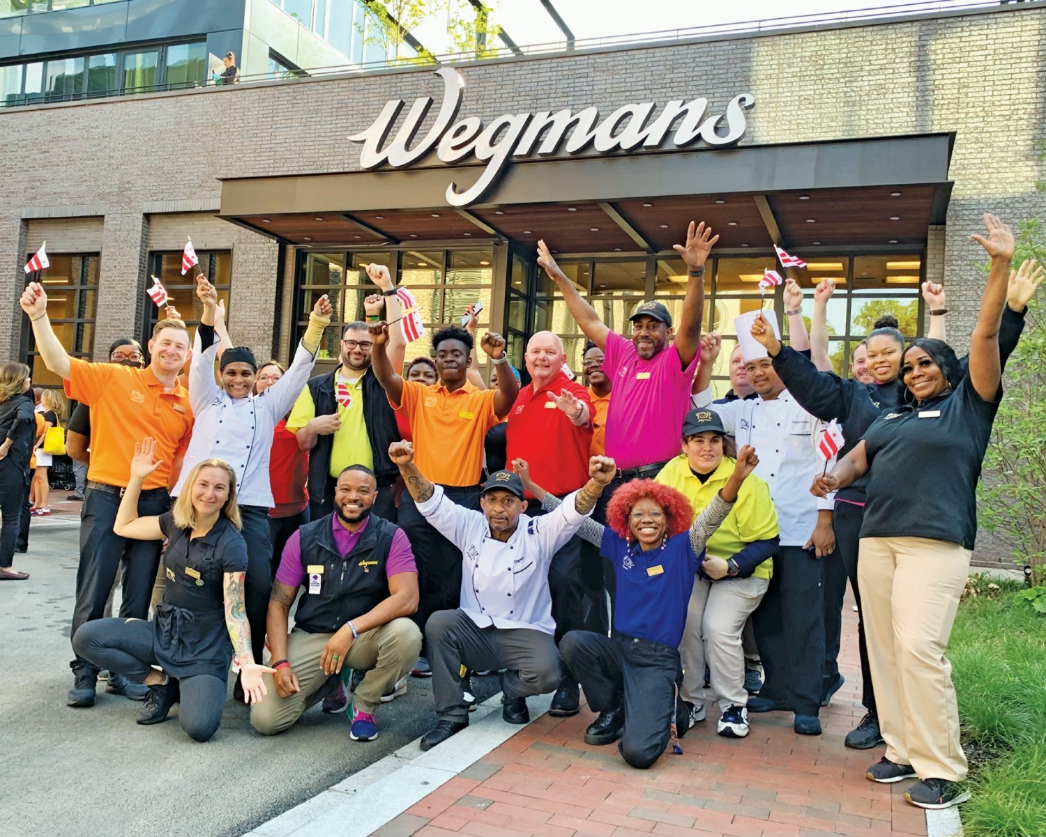 Employees at Wegmans supermarket take group photo.