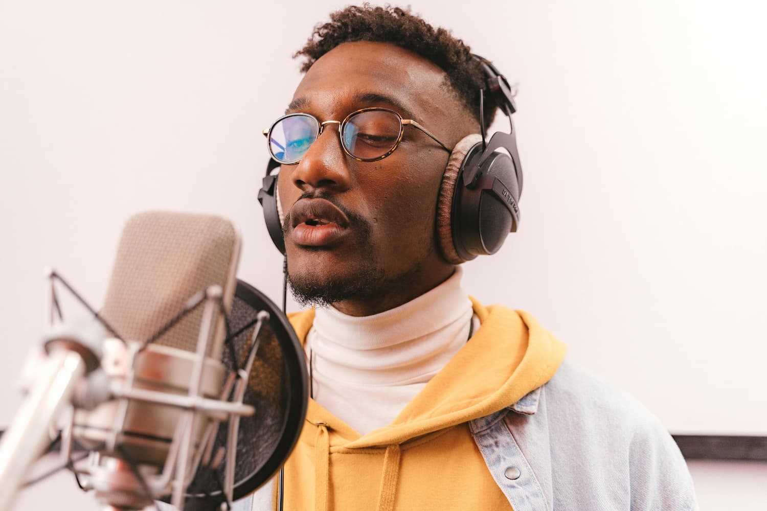  Black man singing into a microphone