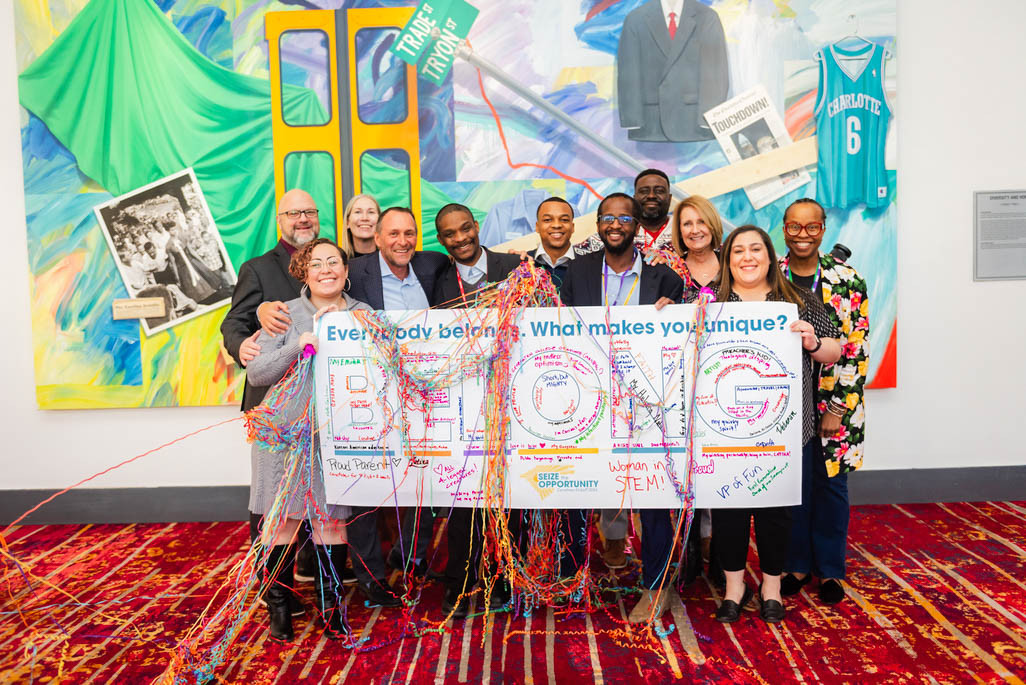 You belong here! Employees pose with our president and D&I leader at a regional meeting.
