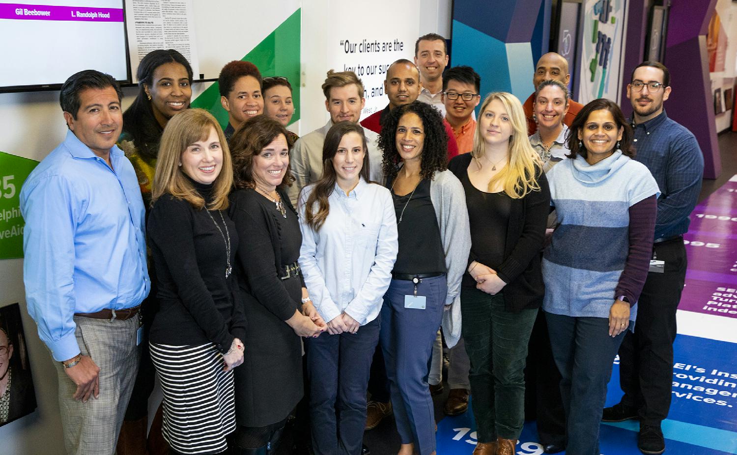 Members of the SEI Diversity Team pose together in the company's History Hallway. 