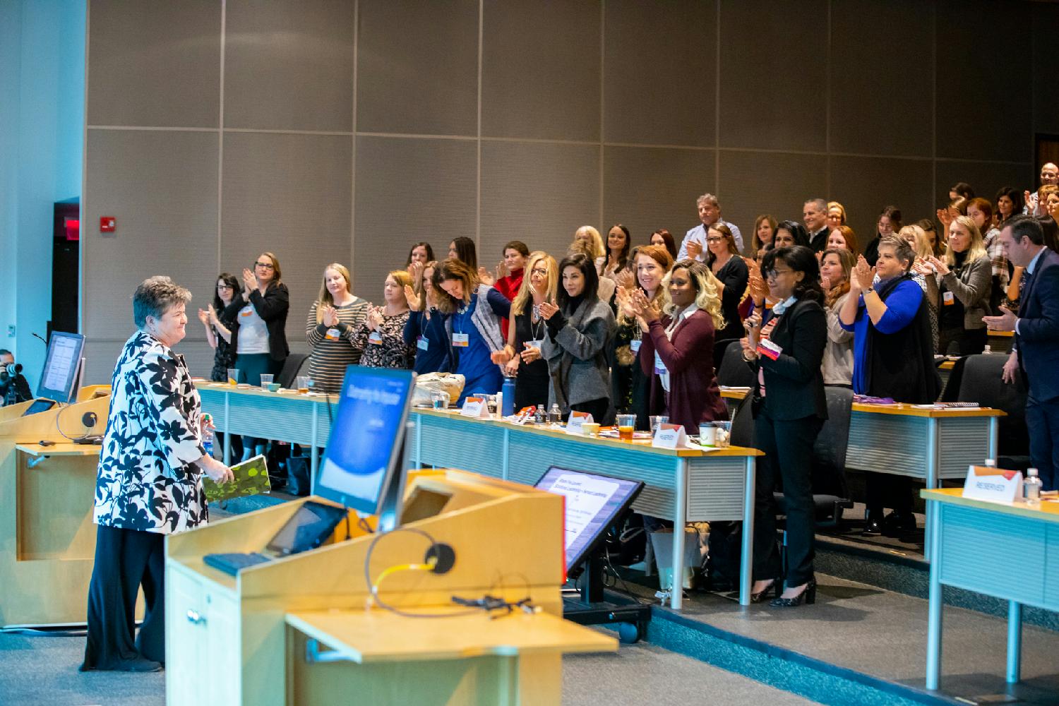 SEI employee Rhonda Cook receives a standing ovation from fellow employees after sharing #HerStory at SEI Women's Network Annual Leadership Summit. 