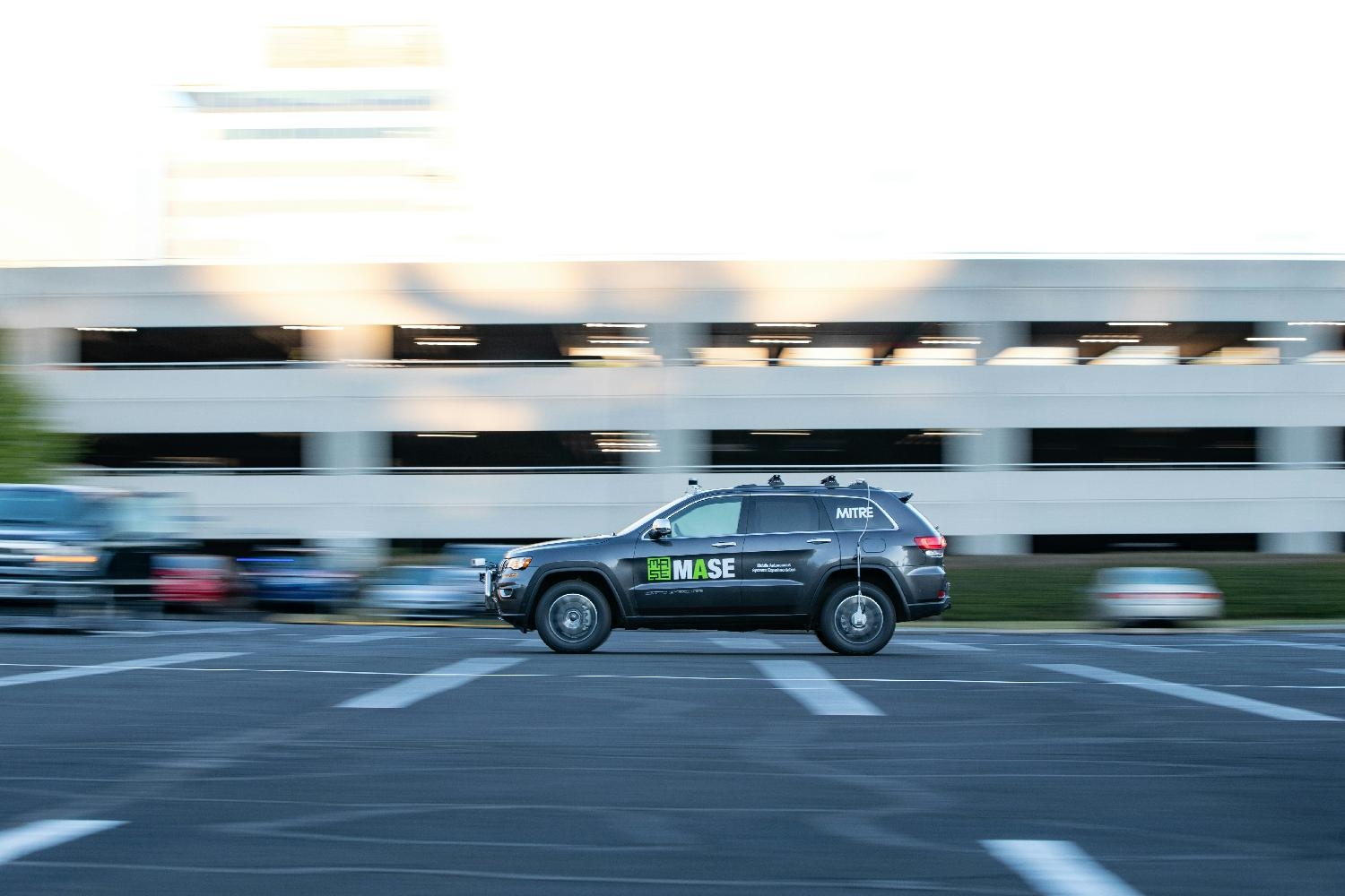 An autonomous vehicle designed by MITRE's MASE Lab navigates a parking lot.