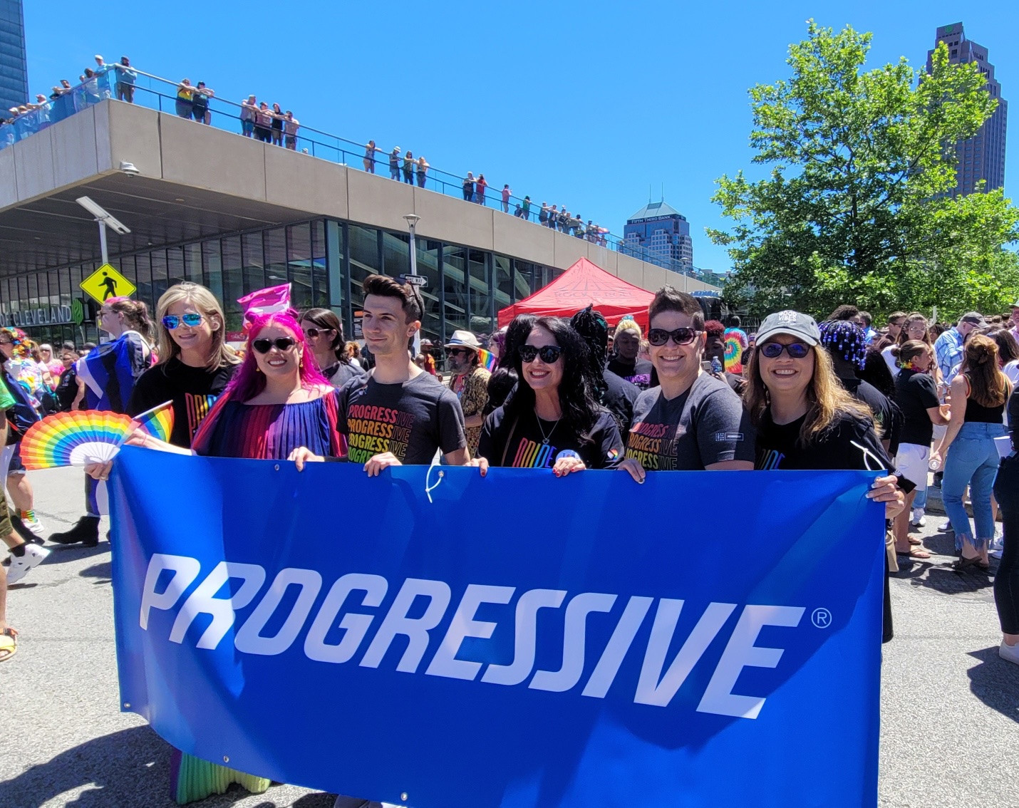 A group of Progressive employees celebrating at a local Pride event in 2022
