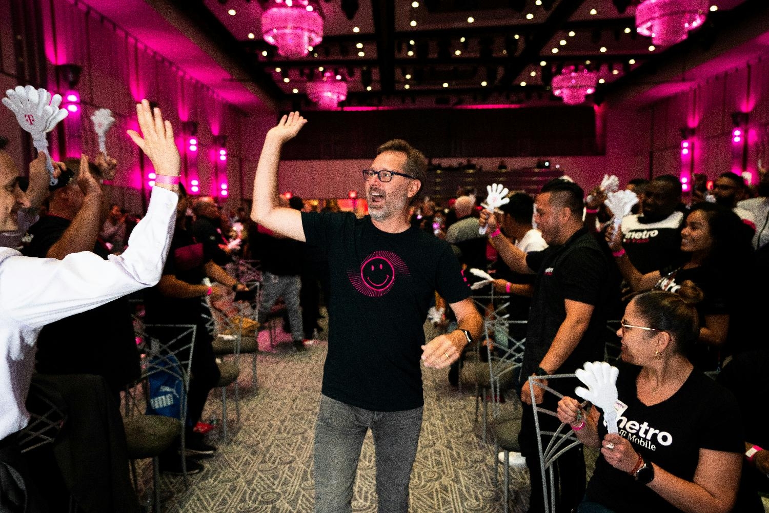 T-Mobile CEO Mike Sievert greets Team Magenta members as he enters a Town Hall meeting with employees in New York.  