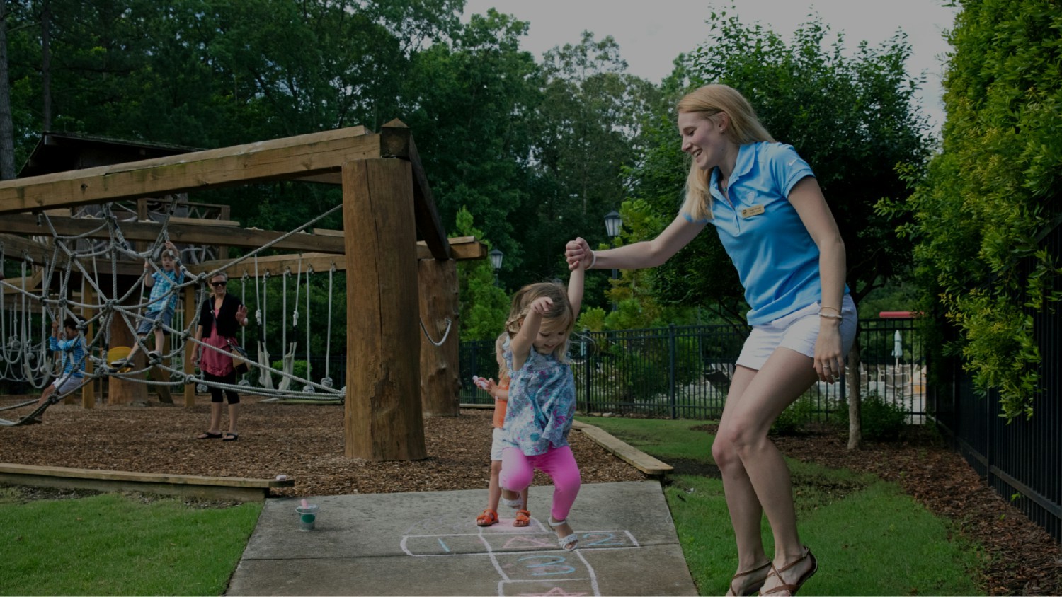 A Toll Brothers employee interacting with a homeowner’s child at a community’s playground