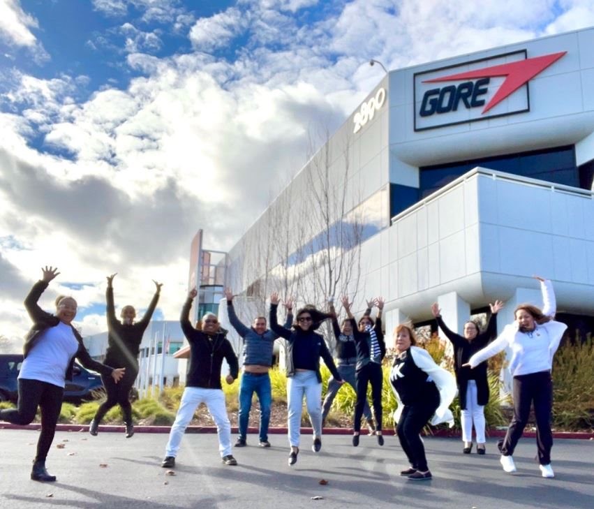 Associates jump for joy outside Gore's Silicon Valley site.