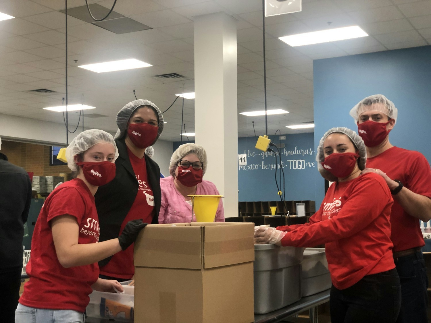 Hy-Vee employees volunteering at a meal packing event in February 2022.