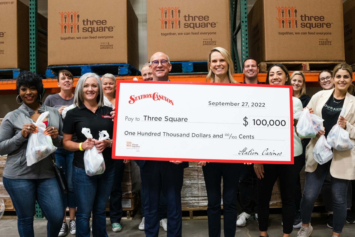 COO (L) Bob Finch and Team Members present $100k donation to Three Square Food Bank